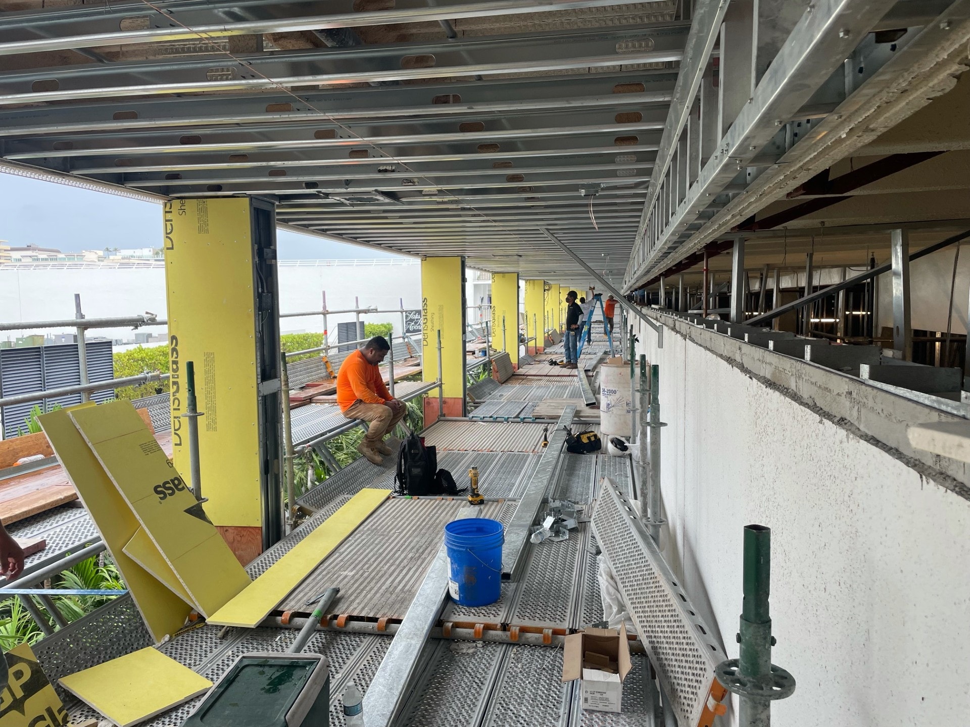 EIFS crew working along scaffolding run on commercial building