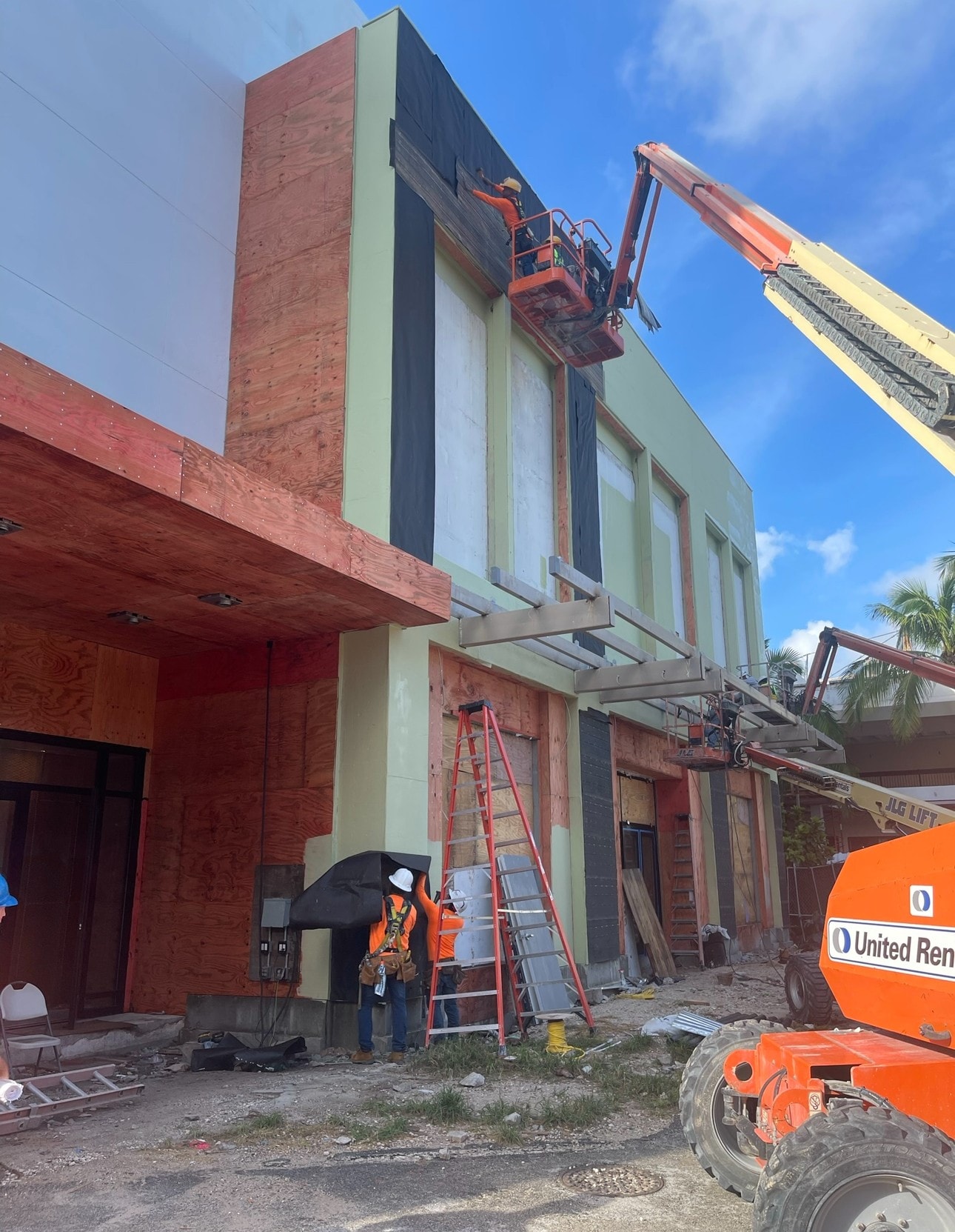 EIFS and sheathing installation with JLG lift on commercial facade