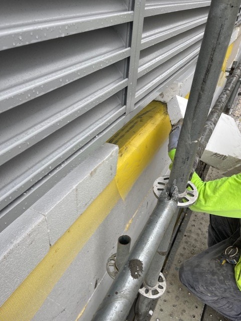 EIFS installation tape and joint detail on scaffolding