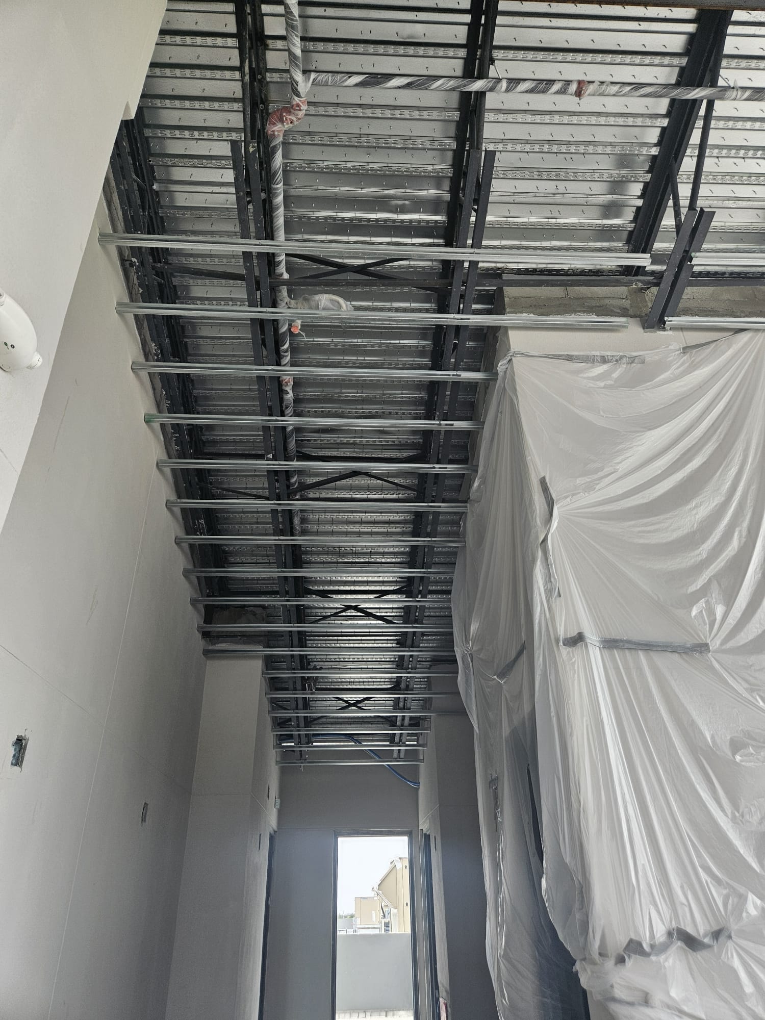 Interior ceiling framing corridor with metal hat channel and drywall