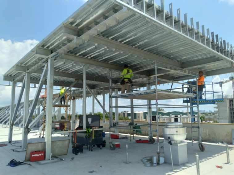 Crew installing rooftop steel framing structure in Miami